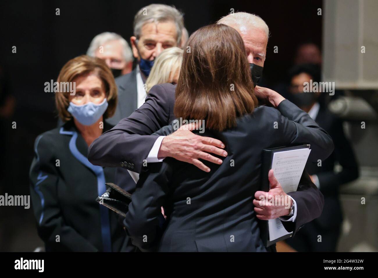 U.S. President Joe Biden hugs an attendee after the funeral ceremony of former Senator John Warner at Washington National Cathedral in Washington, DC, U.S. June 23, 2021. Oliver Contreras/Pool via REUTERS Stock Photo