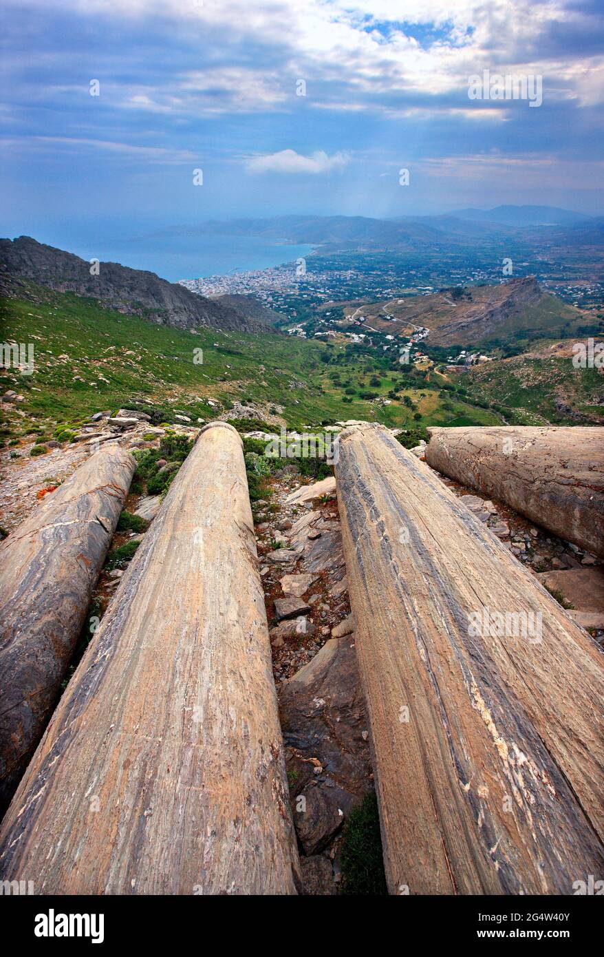 EVIA ISLAND, GREECE. 'Forgotten' ancient columns at an ancient quarry on the slopes of Mount Ochi ('Oche'). In the background, Karystos Stock Photo