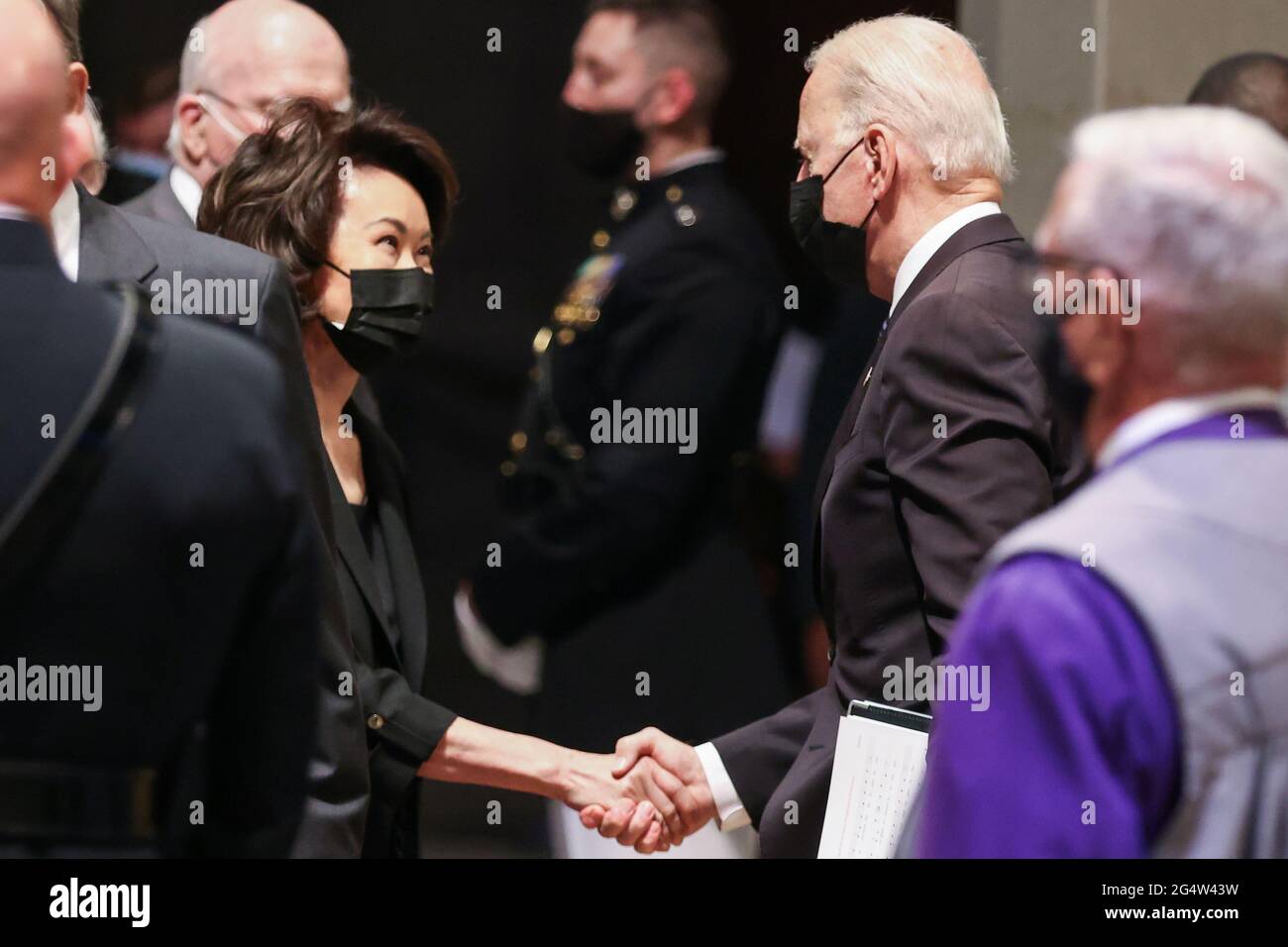 U.S. President Joe Biden shakes hands with Elaine Chao after the funeral ceremony of former Senator John Warner at Washington National Cathedral in Washington, DC, U.S. June 23, 2021. Oliver Contreras/Pool via REUTERS Stock Photo
