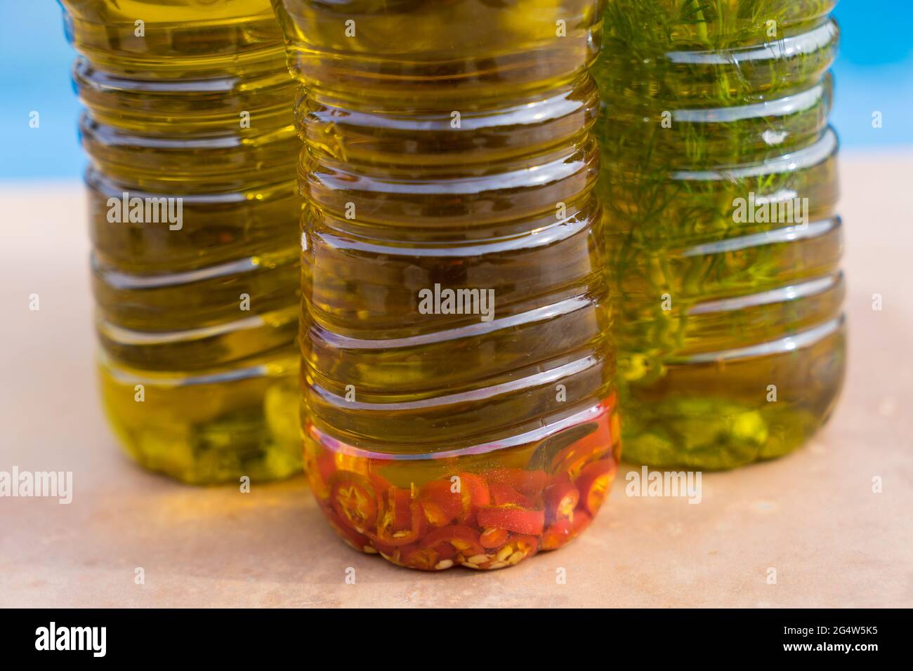 traditional cold-pressed aromatic olive oils with spicy chili and herbs Stock Photo