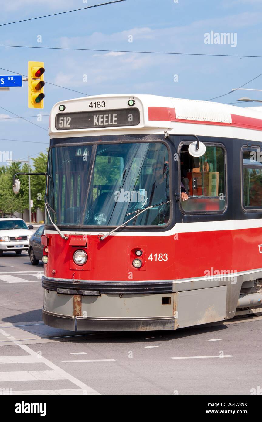 Old TTC streetcar or tram crossing the intersection on a city street in Toronto Stock Photo