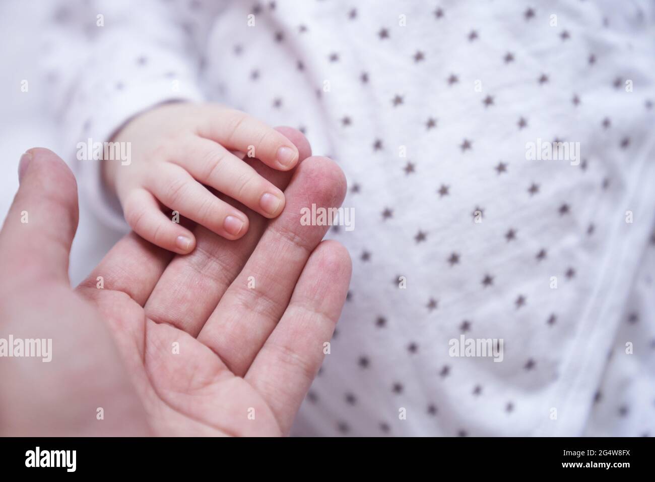 https://c8.alamy.com/comp/2G4W8FX/mothers-hand-holding-baby-hand-the-baby-is-one-month-old-cute-little-hand-with-small-fingers-concept-of-love-and-care-background-high-quality-photo-2G4W8FX.jpg