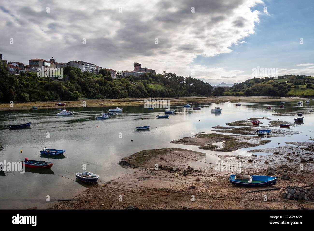 Fishing boats stay on land when the tide is low in the estuary. Stock Photo