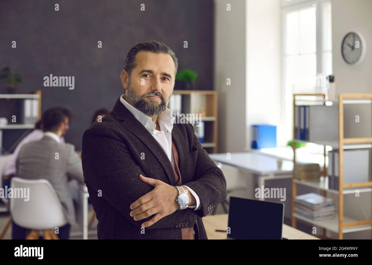 Proud and successful serious mature caucasian team leader portrait in office Stock Photo