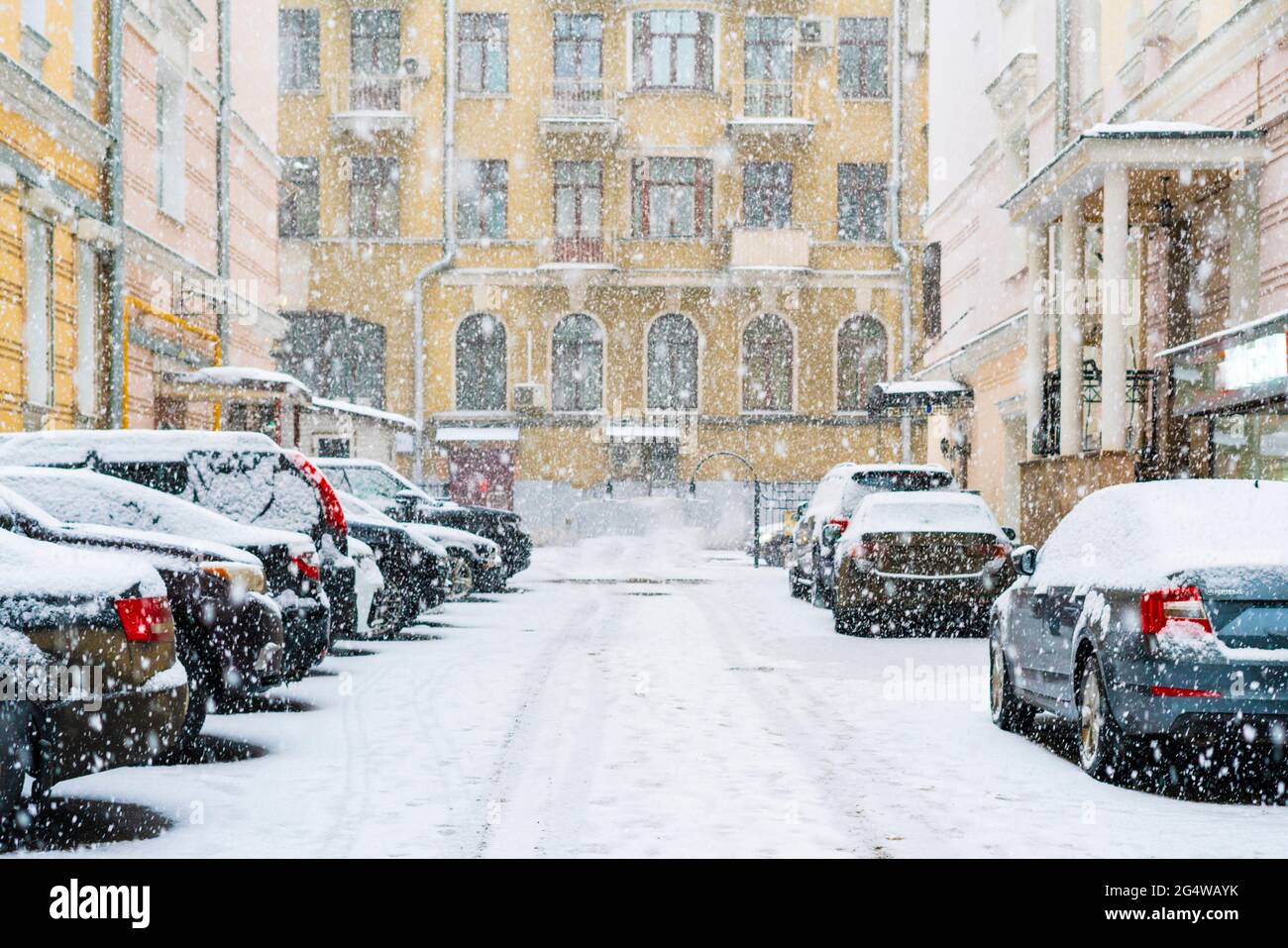parked cars covered with snow in the city neighbourhood cityscape Stock ...
