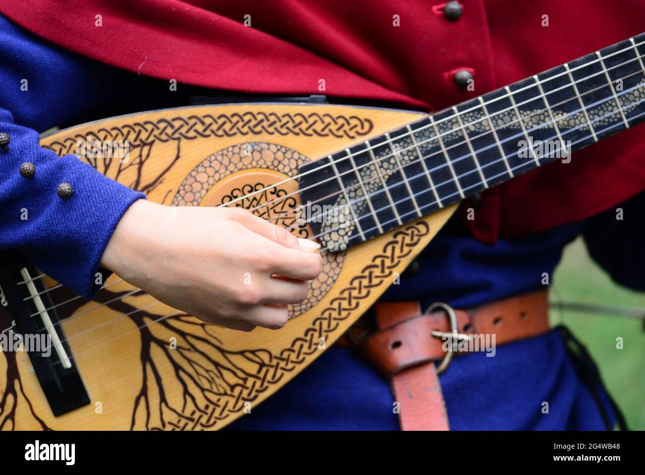 medieval mandolin musical instrument player hand detail Stock Photo