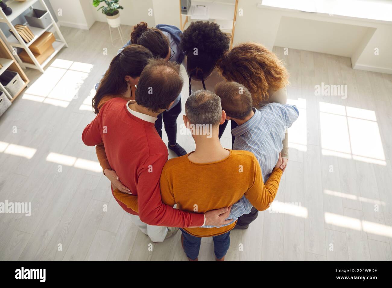 Business people hugging in circle hires stock photography and images