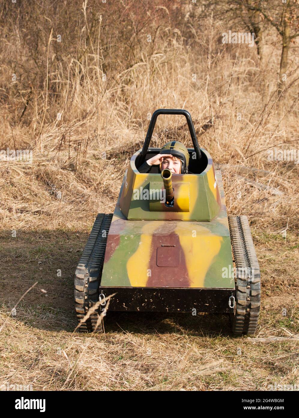 Young boy salute in model of tank Stock Photo - Alamy