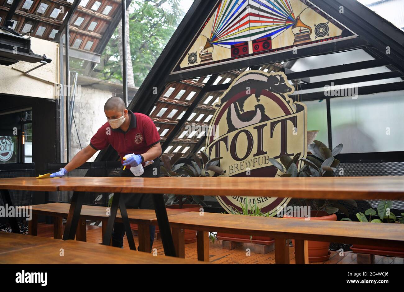 Toit Brewpub is one of the first microbreweries that opened in Bengaluru. Due to the pandemic, all pubs and restaurants had to close because a lockdown was imposed. Staff are sanitizing the place as the restrictions have now been lifted. Bengaluru, India. Stock Photo