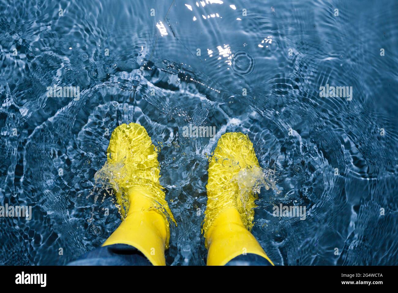 rubber boots splashing in the water Stock Photo Alamy