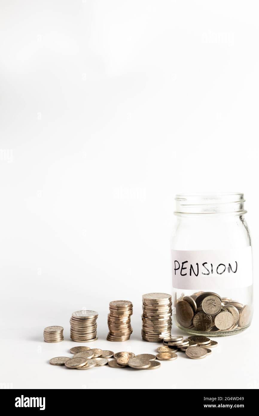 Coins stacked up next to an empty jar with a label on for pension fund. Pension, financial, savings, economy, investment concept Stock Photo
