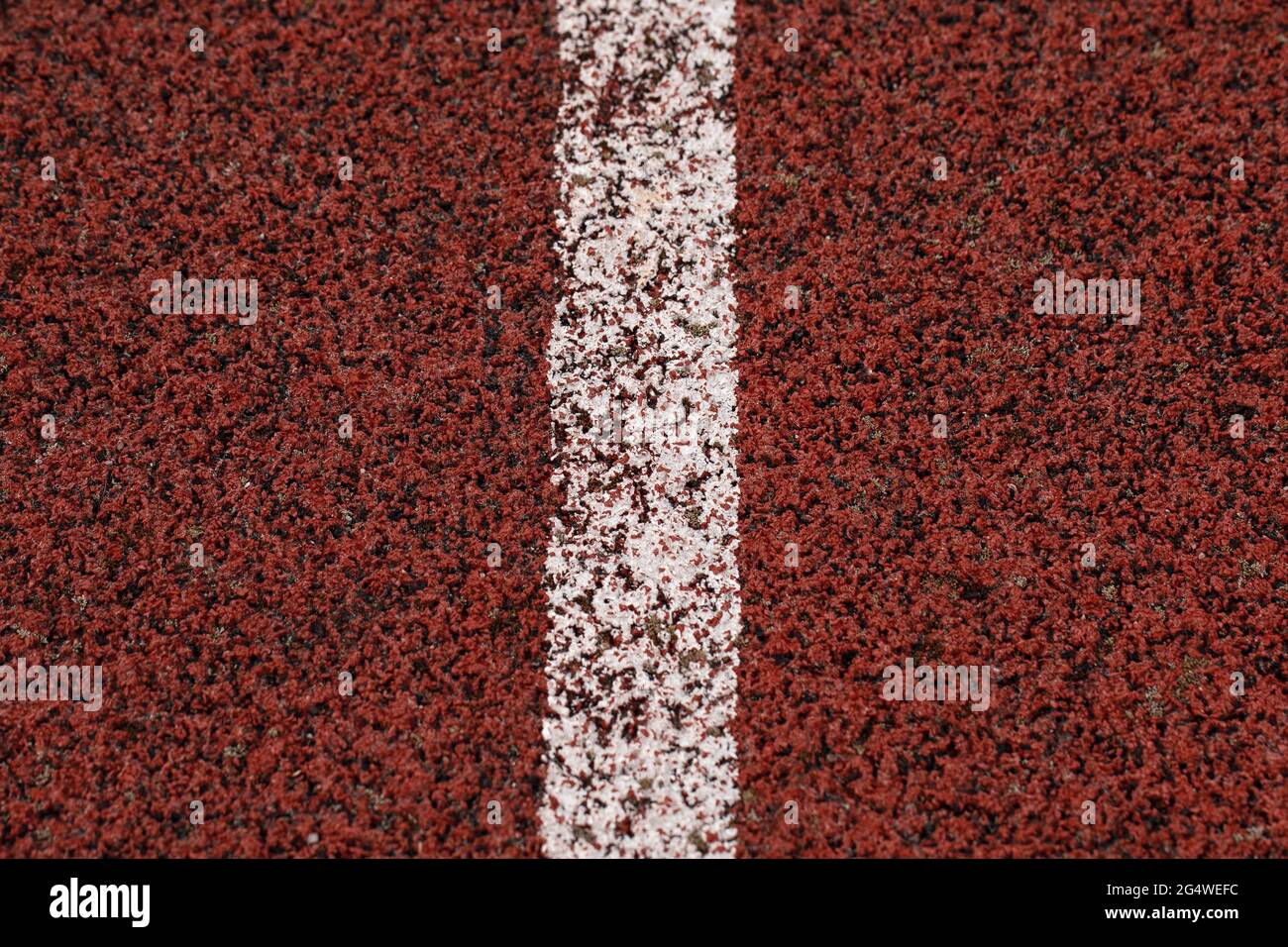 Red racing track with white line rubber texture in stadium texture background Stock Photo