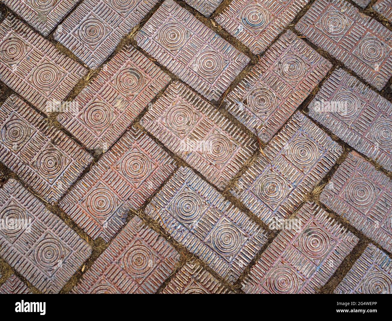Fancy brick pavers with carved decorative concentric circles and lines in a herringbone pattern along a walkway in Columbus, Ohio. Stock Photo