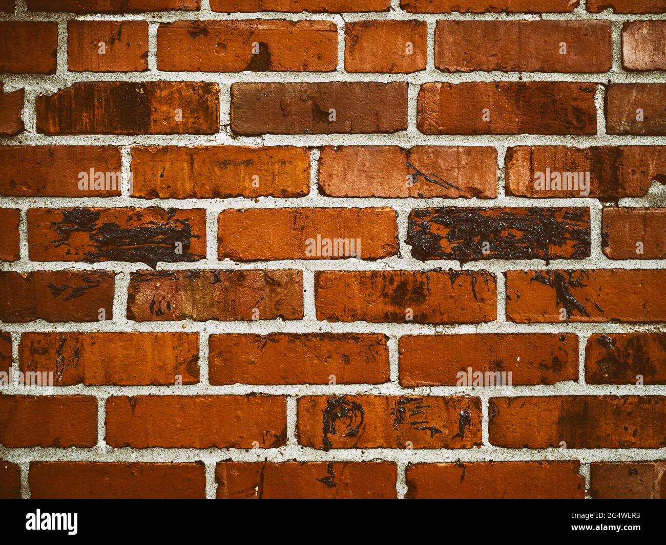 Dark red orange brick wall horizontal abstract background pattern with black  tar pattern Stock Photo
