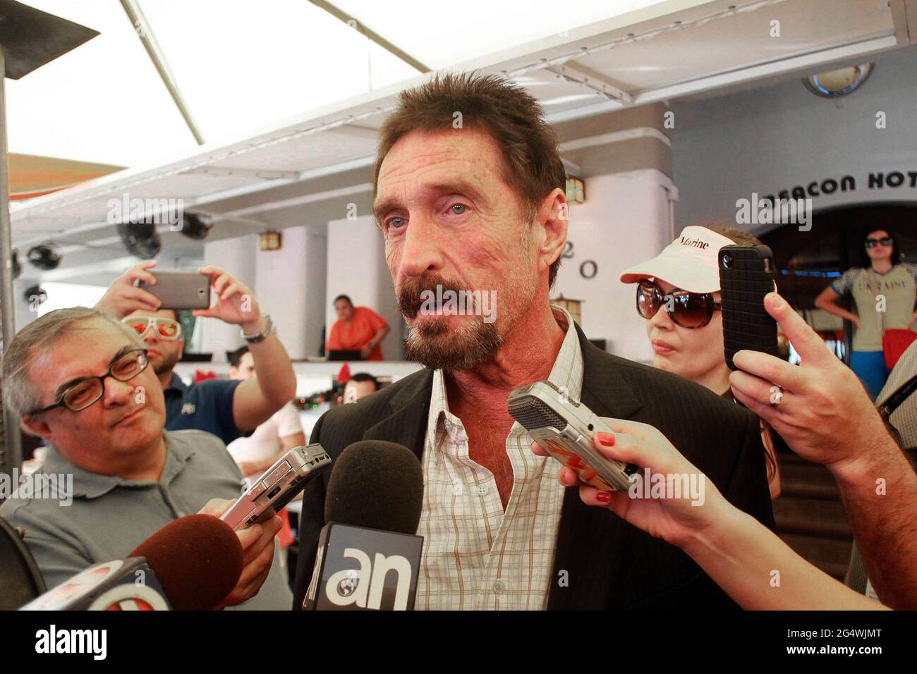 Miami, USA. 13th Dec, 2012. John McAfee speaks to the Miami media outside the Beacon Hotel in Miami, Florida, on December 13, 2012. John McAfee, the controversial guru of computer anti-virus software, denied Thursday in Miami Beach that he's been interviewed by Internal Revenue Service and FBI agents after arriving the previous night following deportation from Guatemala. (Photo by C.M. Guerrero/Miami Herald/MCT/Sipa USA) Credit: Sipa USA/Alamy Live News Stock Photo