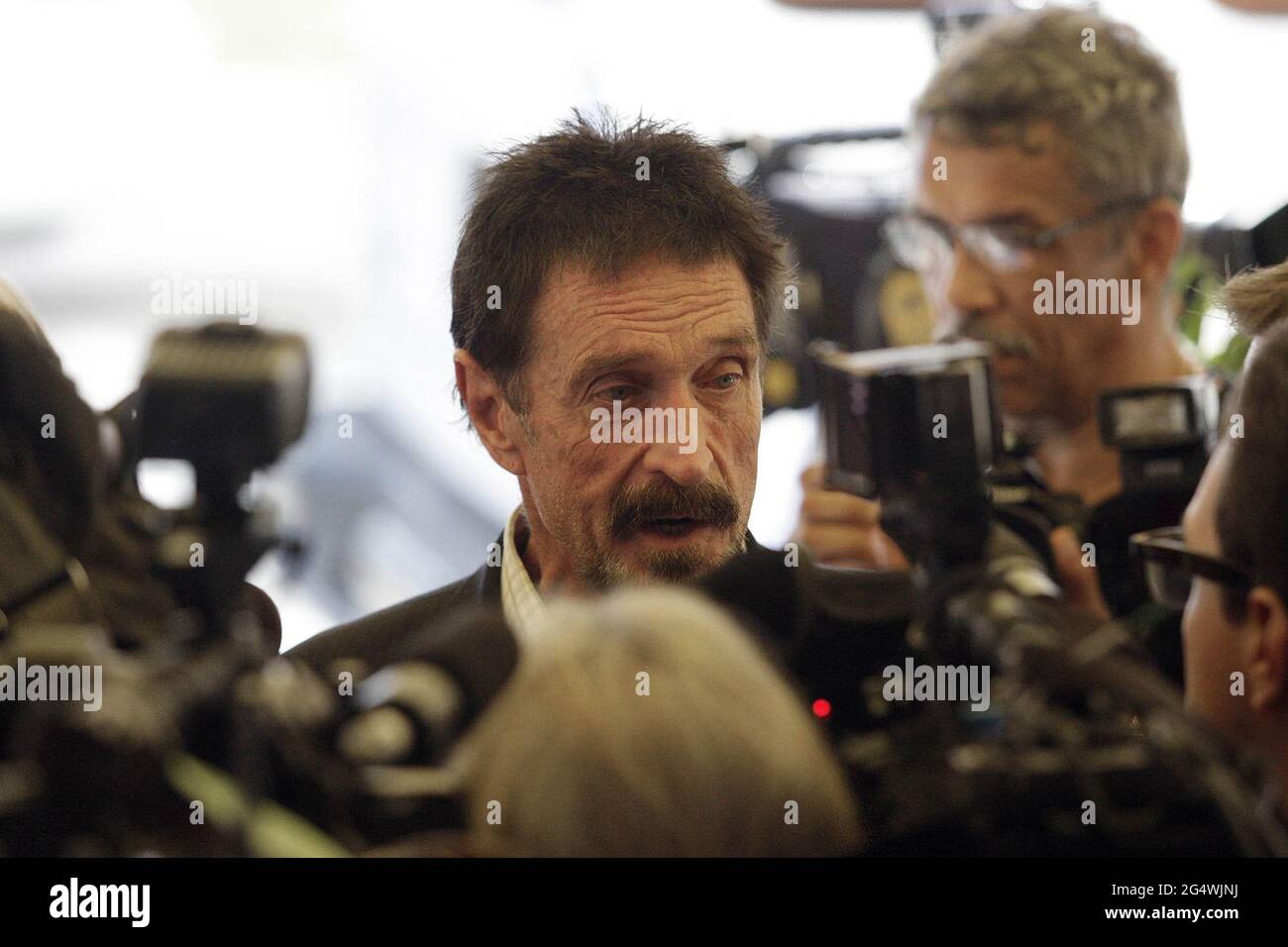 Miami, USA. 13th Dec, 2012. John McAfee speaks to the Miami media outside the Beacon Hotel in Miami, Florida, on December 13, 2012. John McAfee, the controversial guru of computer anti-virus software, denied Thursday in Miami Beach that he's been interviewed by Internal Revenue Service and FBI agents after arriving the previous night following deportation from Guatemala. (Photo by C.M. Guerrero/Miami Herald/MCT/Sipa USA) Credit: Sipa USA/Alamy Live News Stock Photo