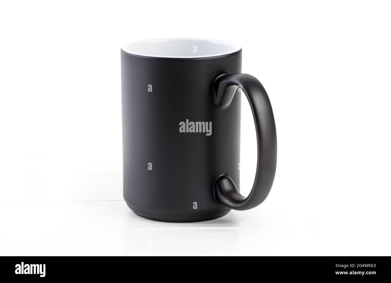 Black ceramic cup with white inside on a white background Stock Photo