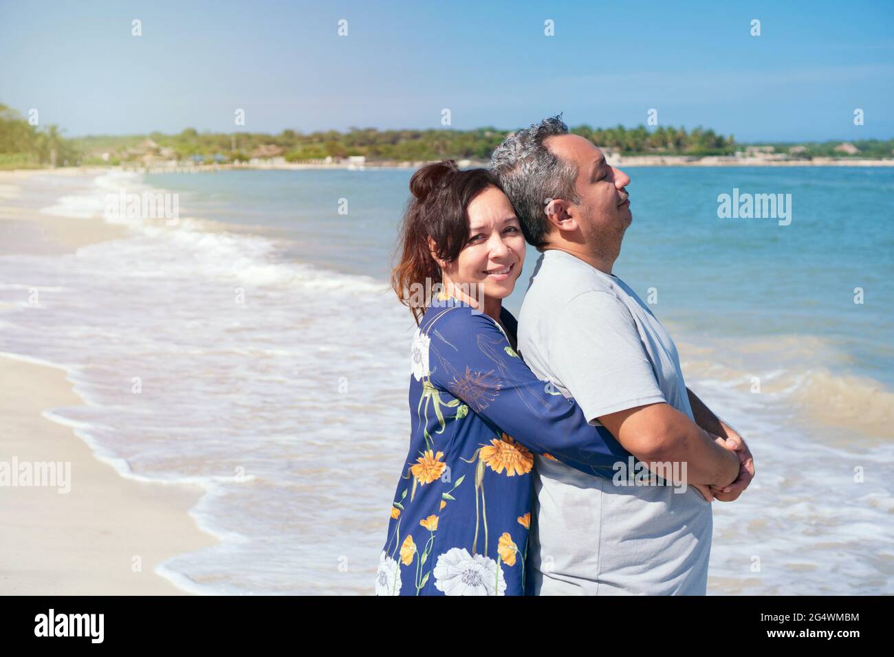 Middle-aged couple embracing on a beach. Stock Photo
