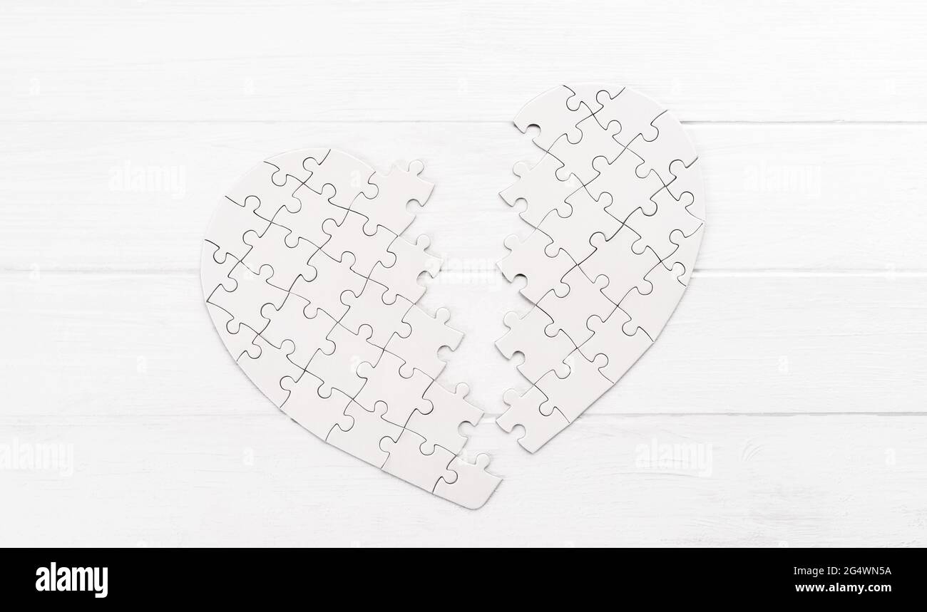 Bold heart shaped puzzle on white table Stock Photo