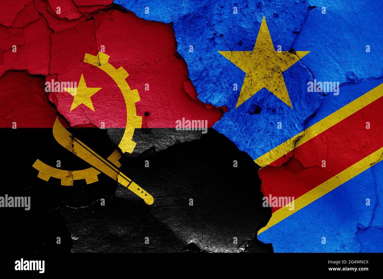 flags of Angola and DR Congo painted on cracked wall Stock Photo