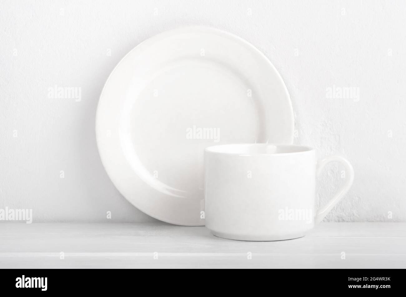 Set of cup and plate on white background Stock Photo - Alamy