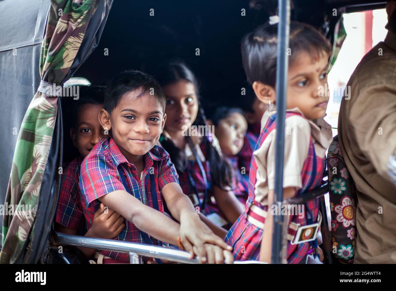 Indian auto rickshaw on a school run with young schoolboys and schoolgirl passengers, Udupi, Karnataka, India Stock Photo