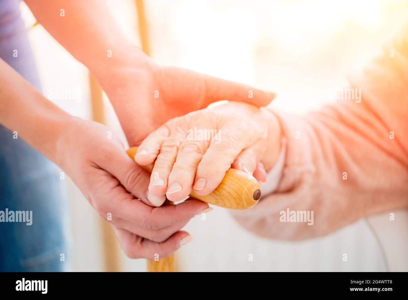Helping hands of youngster for old woman Stock Photo - Alamy