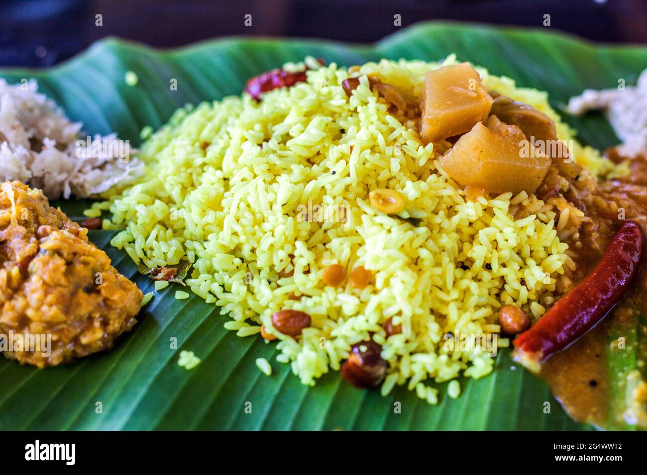Close up of Indian vegetarian meal with yellow saffron rice served on