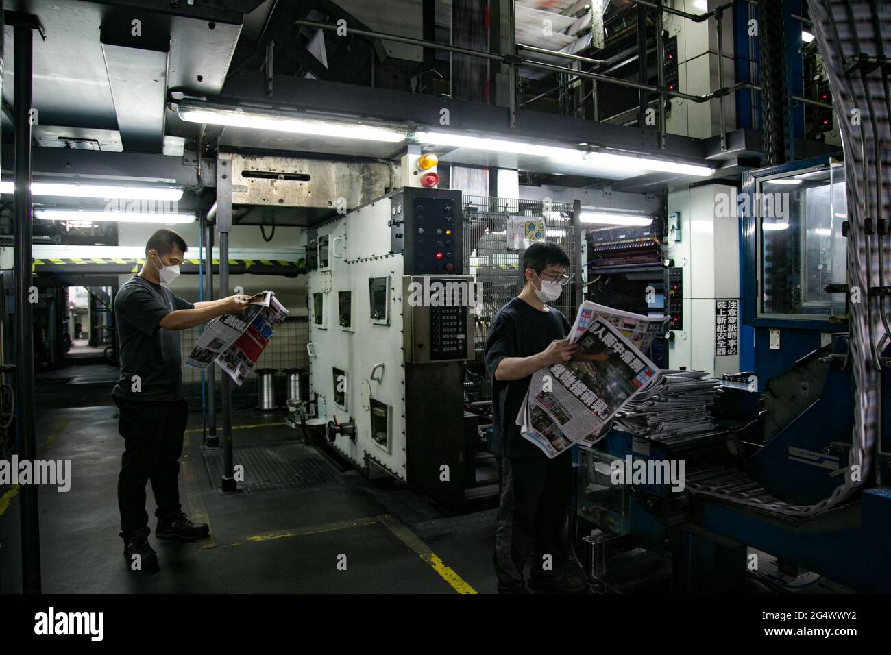 Hong Kong, China. 24th June, 2021. Apple daily workers checking the newspaper printing.Hong Kong's largest pro-democracy newspaper, Apple Daily, is shutting down after printing its final edition on 25/6/2021 and it raises huge concern on the freedom of press in Hong Kong. National security police raided its offices, freezing its assets and accounts, crippling the company and forcing its demise. Credit: SOPA Images Limited/Alamy Live News Stock Photo