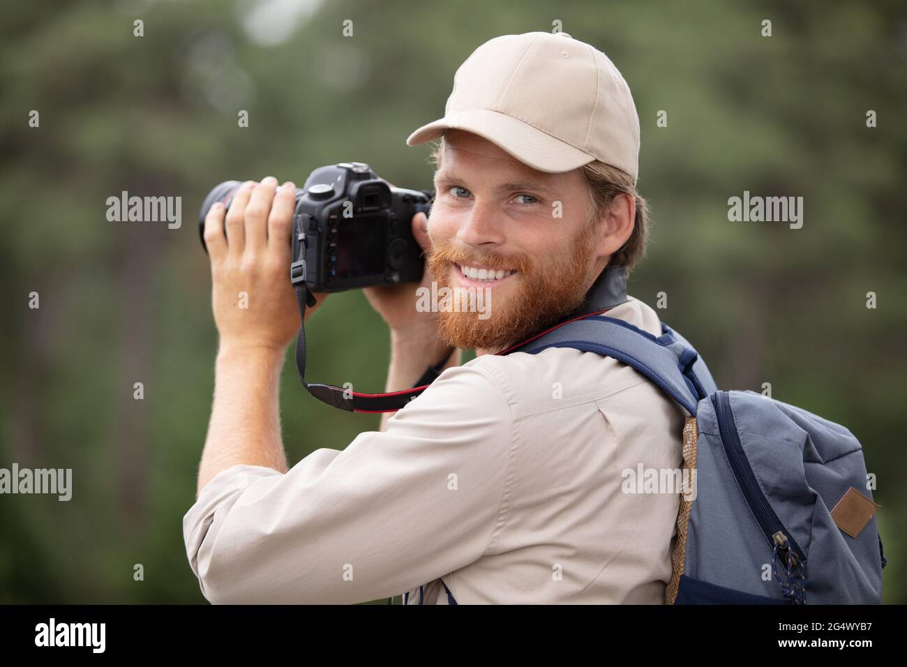 photographer hiking in nature looking at camera Stock Photo Alamy