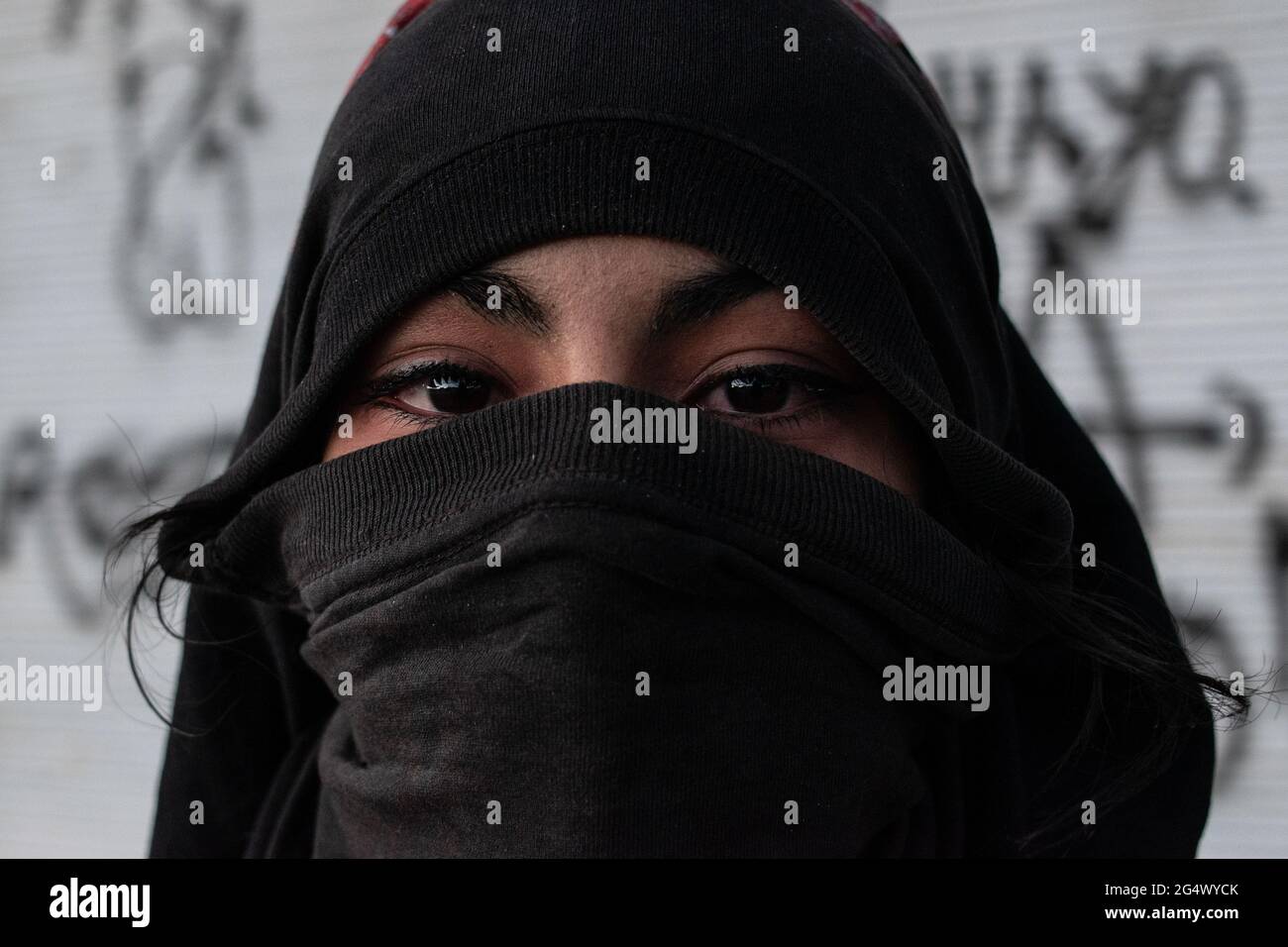 Bogota, Colombia. 21st June, 2021. A portrait of a women from the front line as clashes between demonstratros and Colombia's riot police erupt anti-government protest raise in Bogota Colombia against the government of president Ivan Duque, inequalities and abuse of authority by police. Credit: Long Visual Press/Alamy Live News Stock Photo