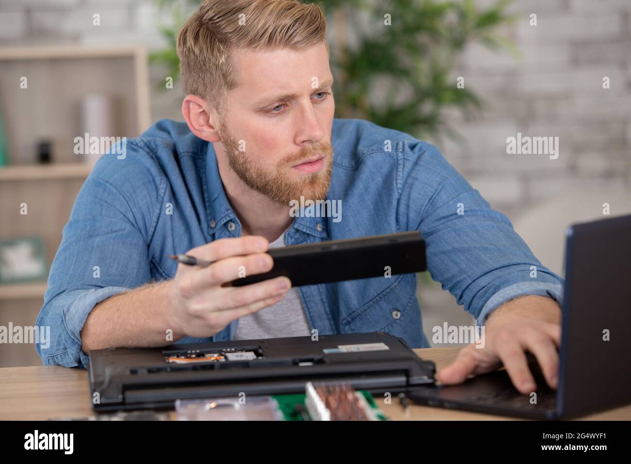thoughtful it developer thinking about fixing software bugs Stock Photo