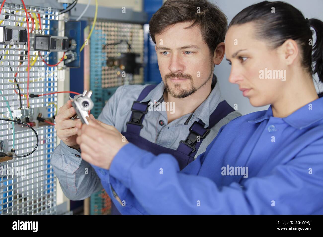 team of technicians working together on servers Stock Photo