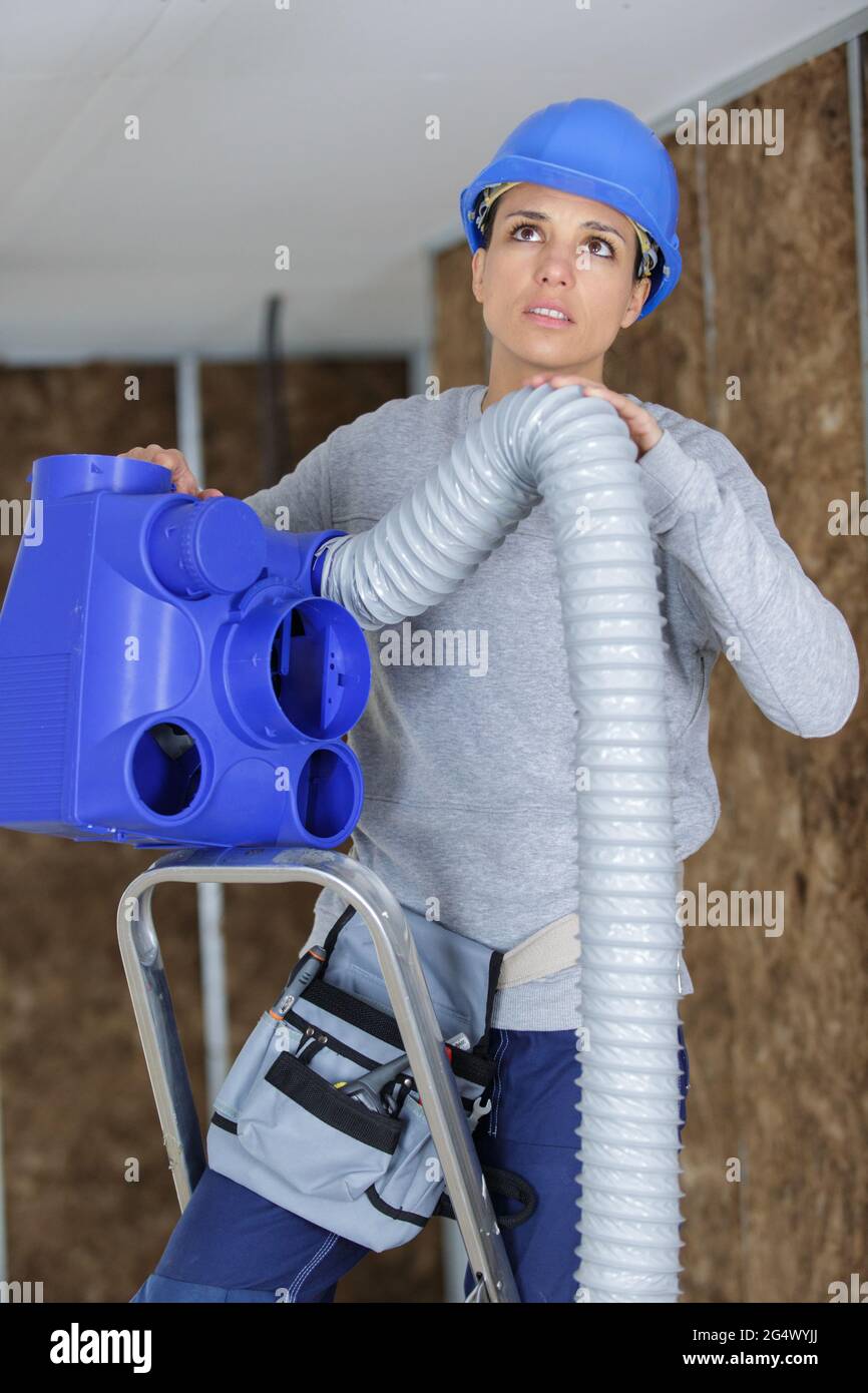 female worker fitting ventilation system Stock Photo Alamy