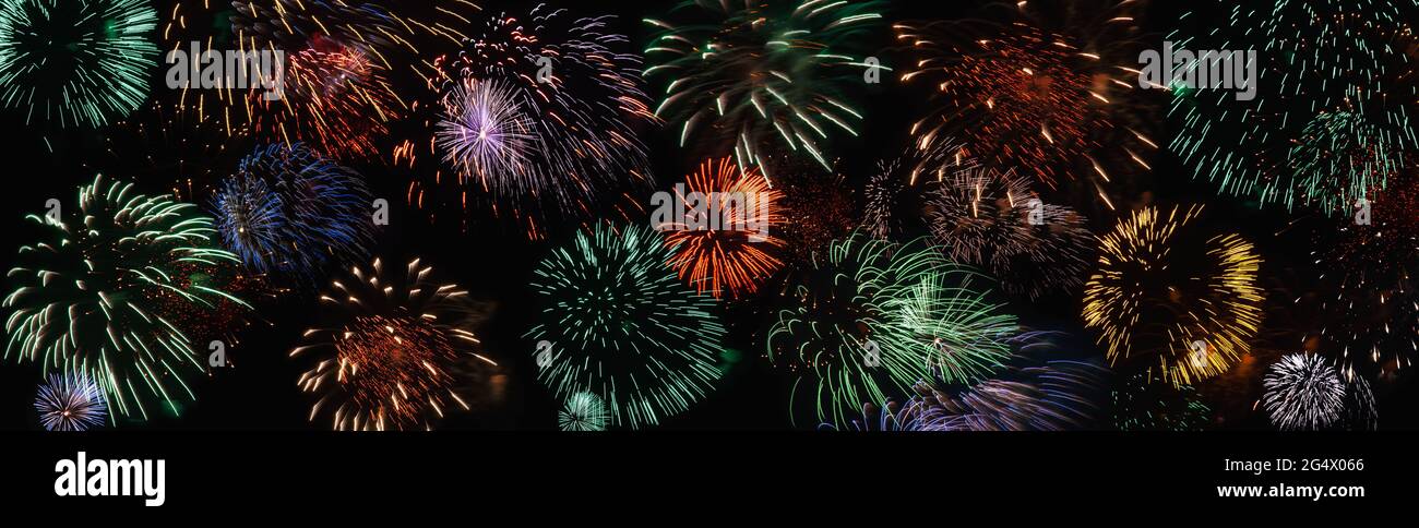 Colorful firework in black night sky, wide banner for holiday background Stock Photo