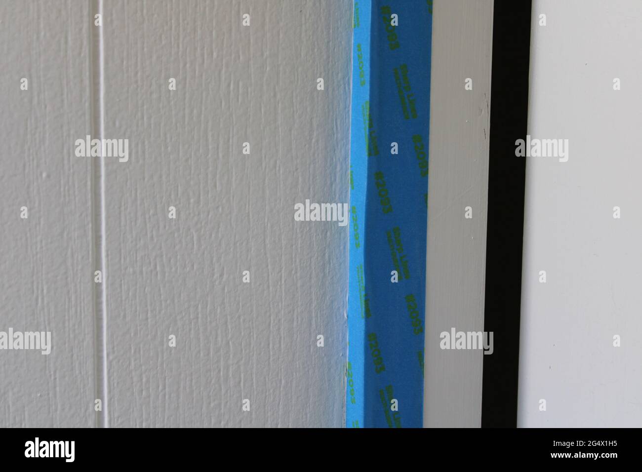 Painter's Tape On Wall Trim in Preparation for Painting Stock Photo