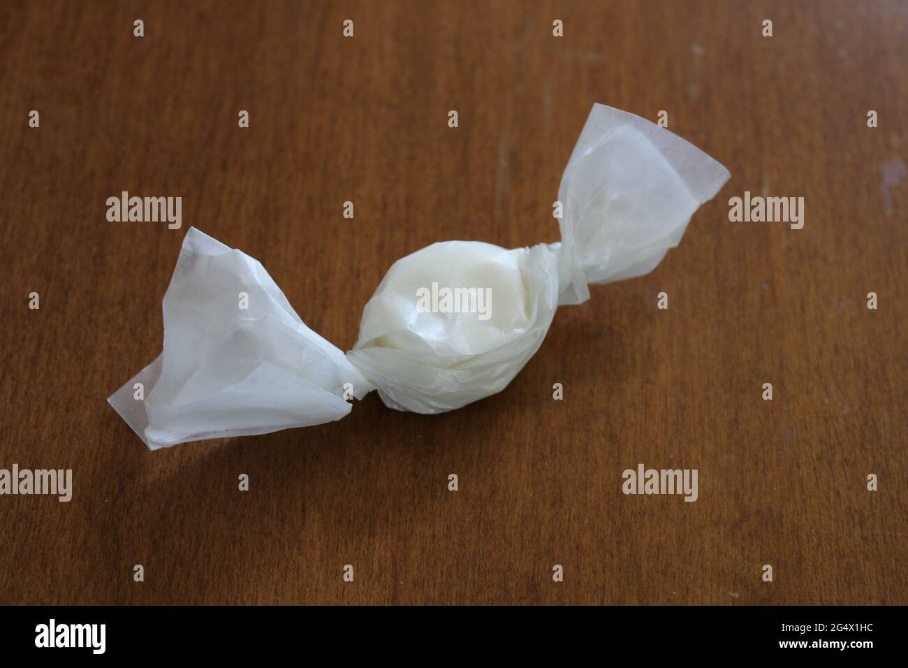 A Single Piece of Vanilla OldFashioned Saltwater Taffy Wrapped in Wax