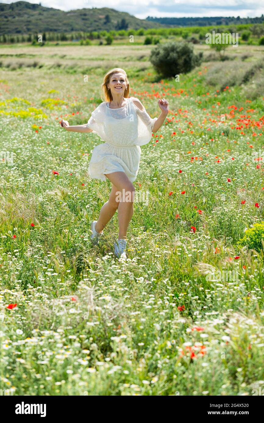Young woman running in field of flowers hires stock photography and images Alamy