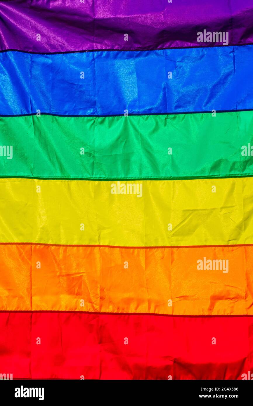 Rainbow pride flag hanging in the summer sunshine Stock Photo