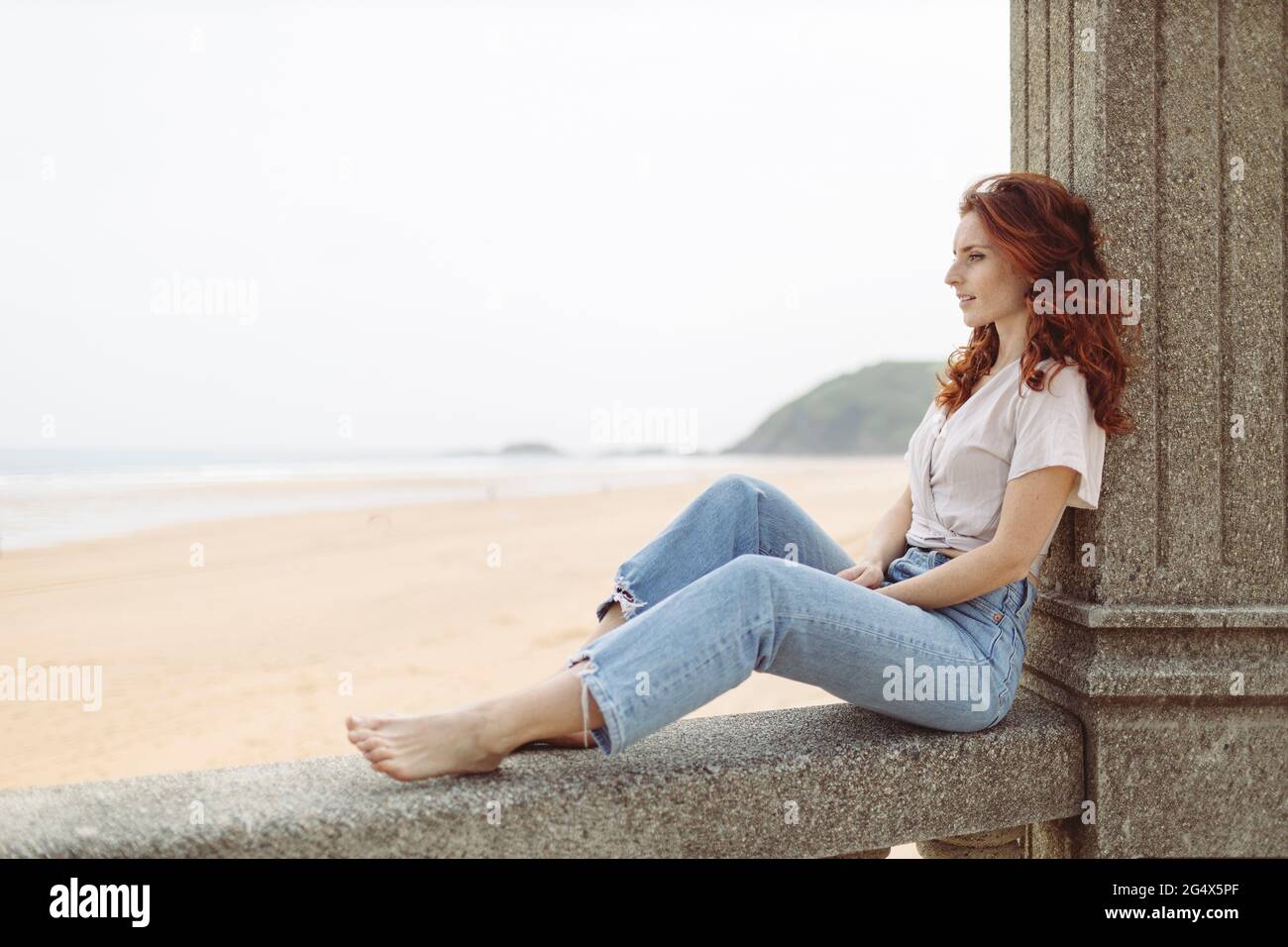 Side view of woman sitting on wall hi-res stock photography and images ...