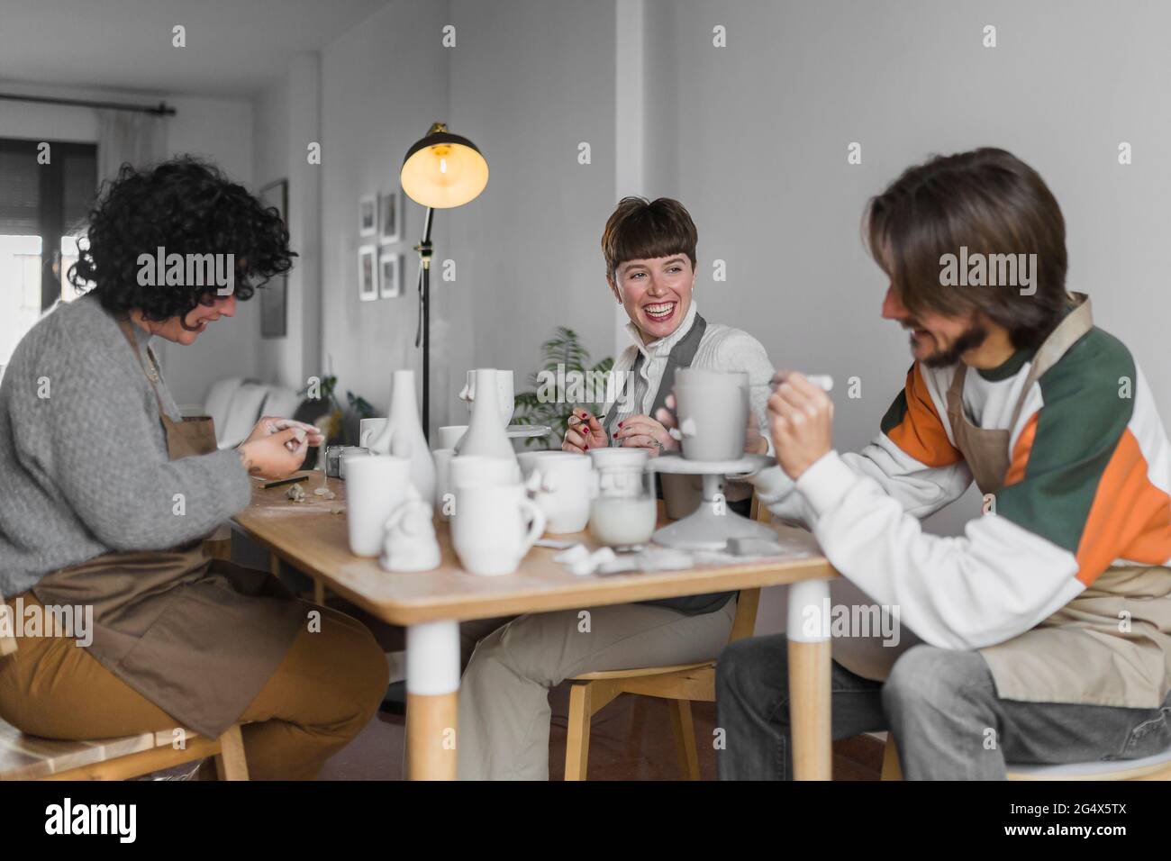Smiling colleagues working together at workshop Stock Photo