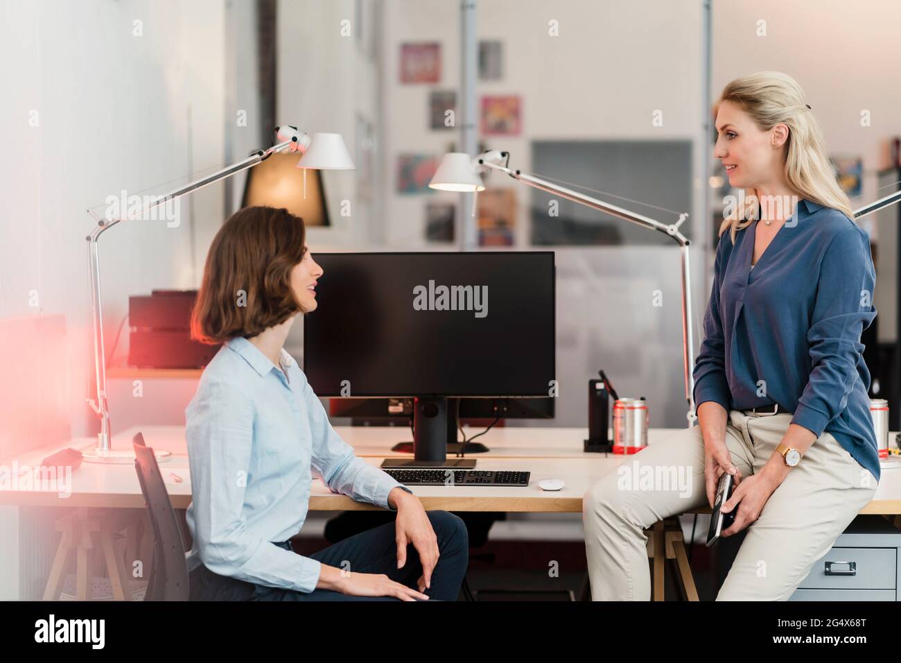 Young female professionals discussing in office Stock Photo