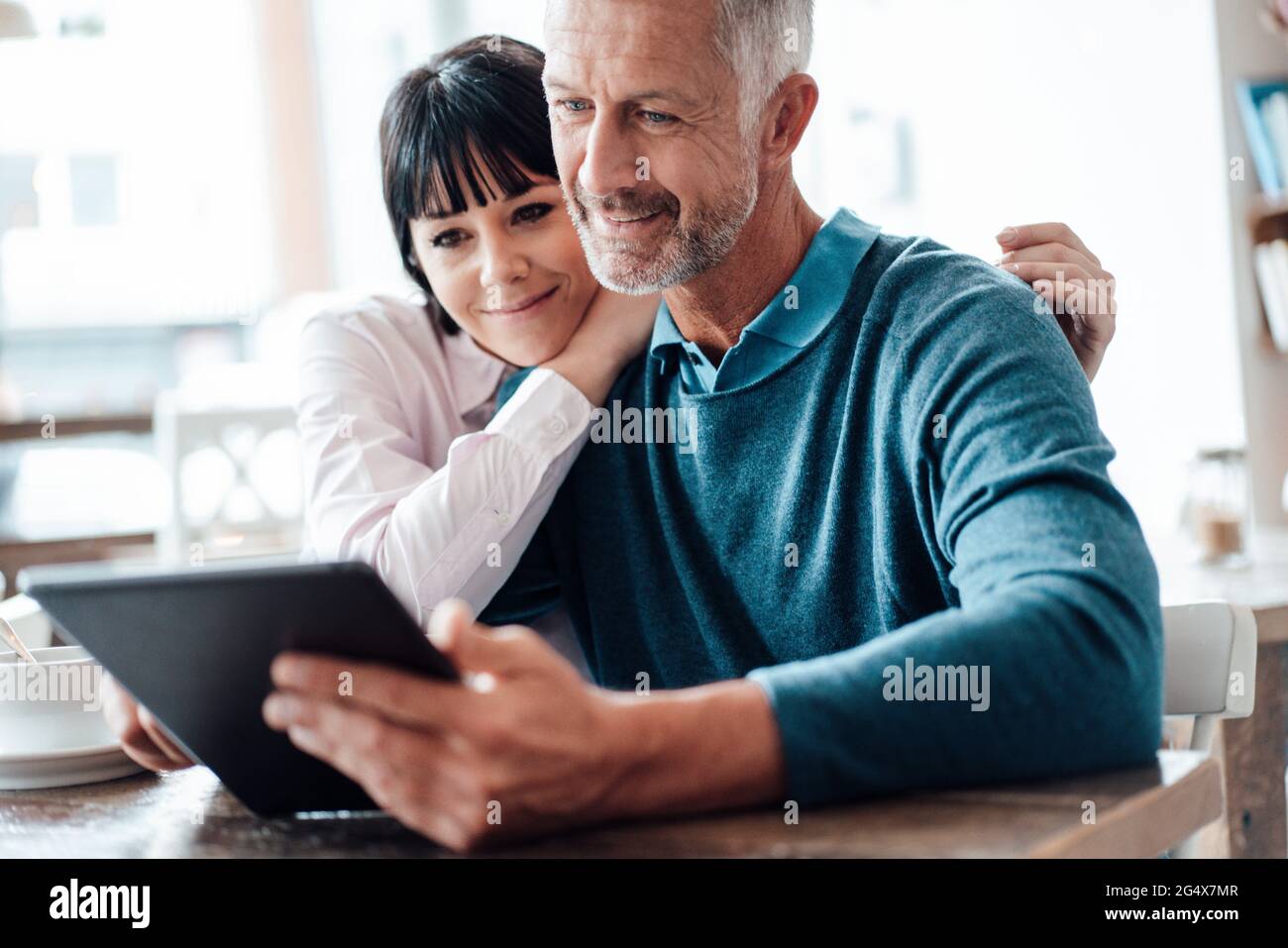Business couple using digital tablet at cafe Stock Photo