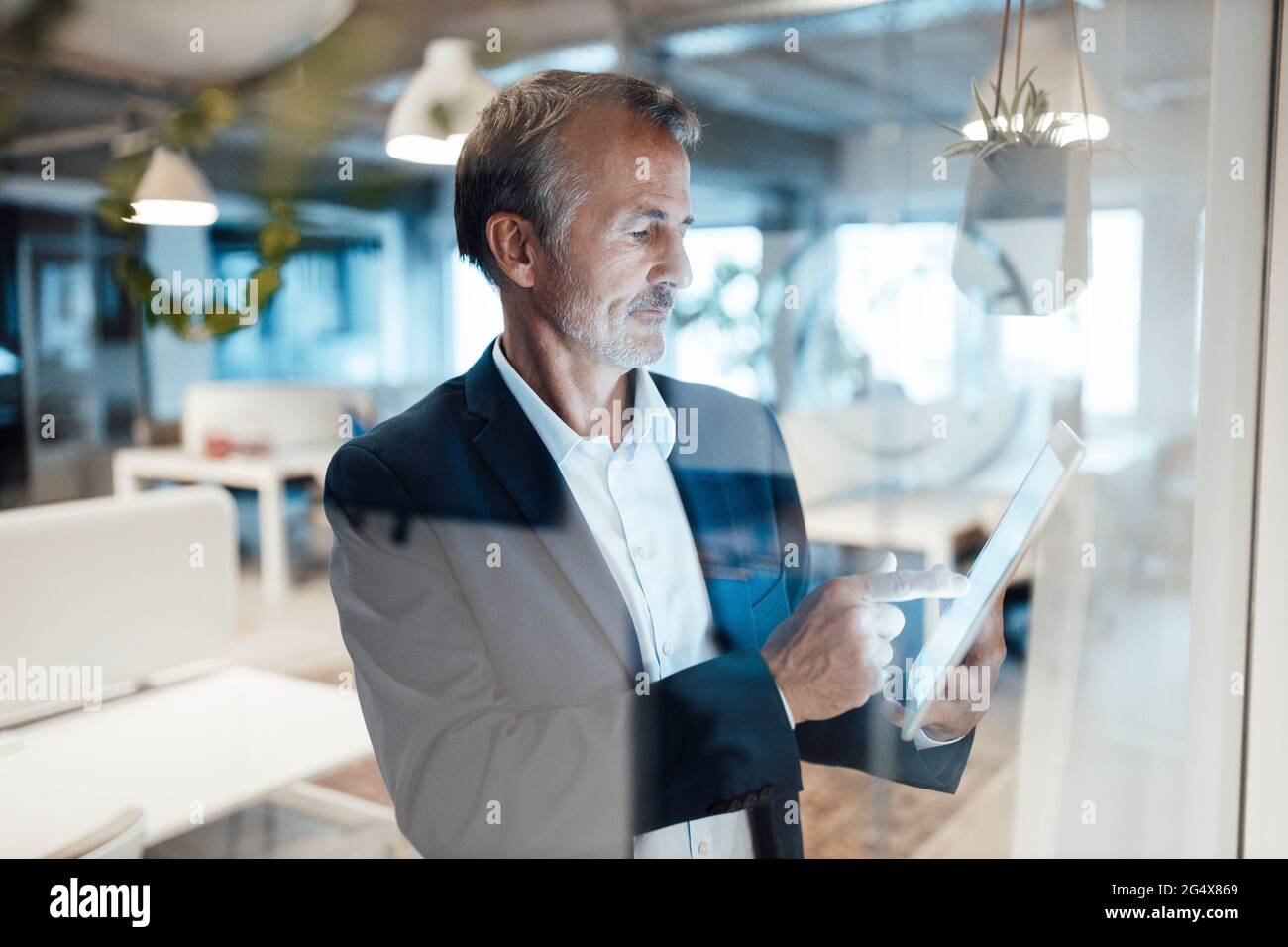 Senior businessman using digital tablet in office Stock Photo
