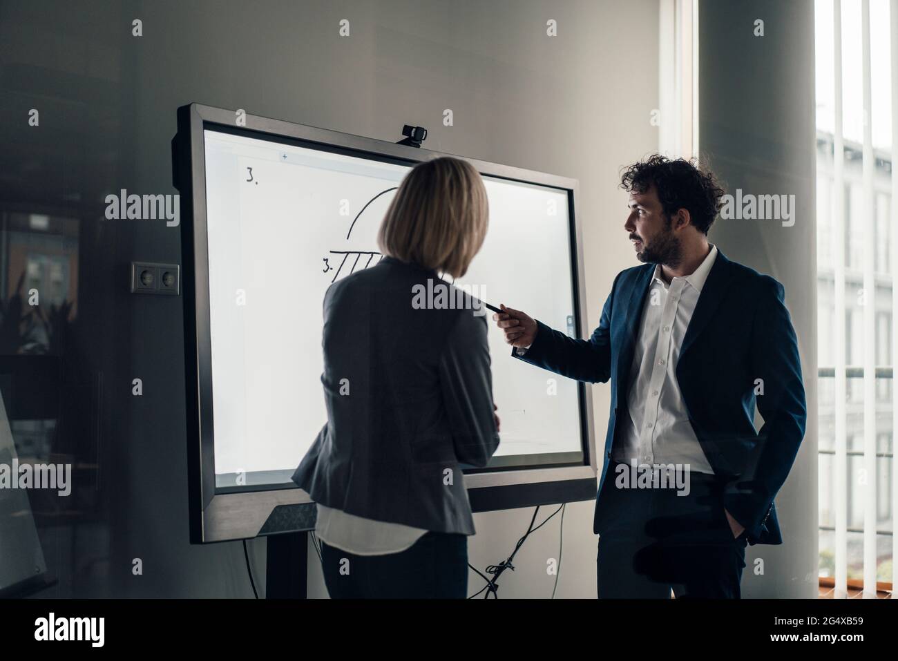 Professional team working together on projection screen at office Stock Photo