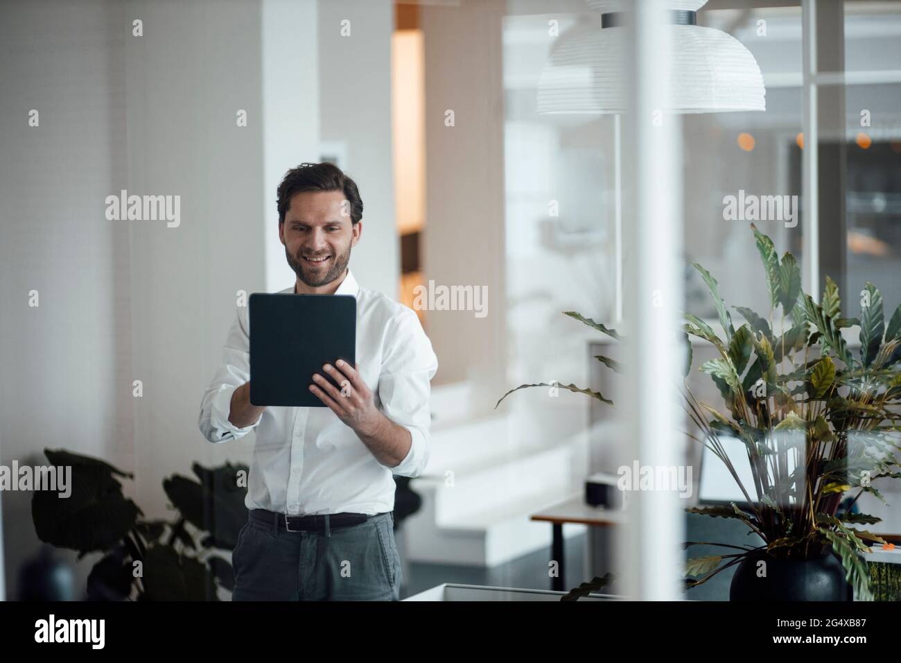 Male entrepreneur using digital tablet at office Stock Photo