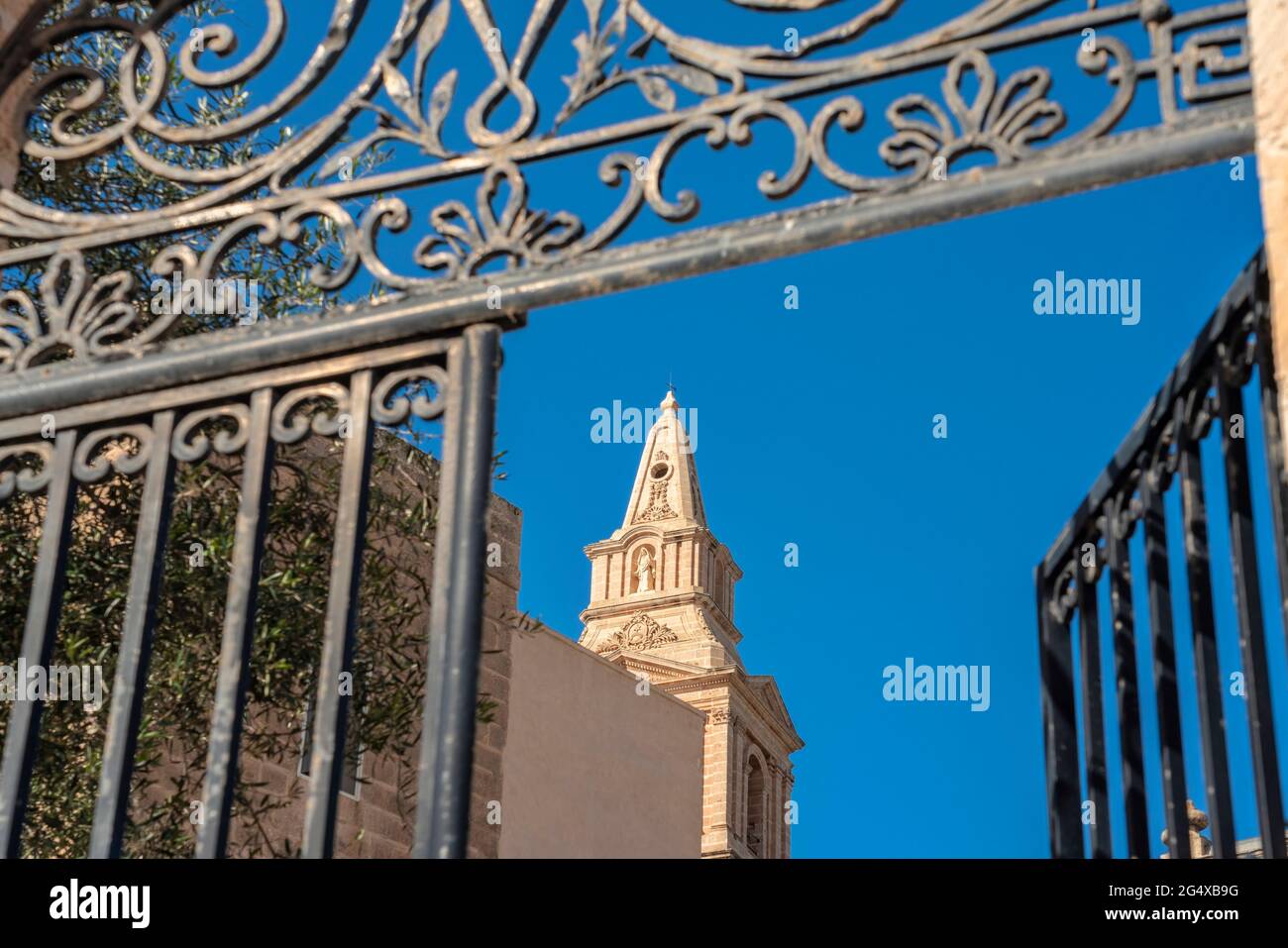 Malta, Northern Region, Mellieha, Bell tower of Parish Church of Nativity of Virgin Mary seen through open gate Stock Photo