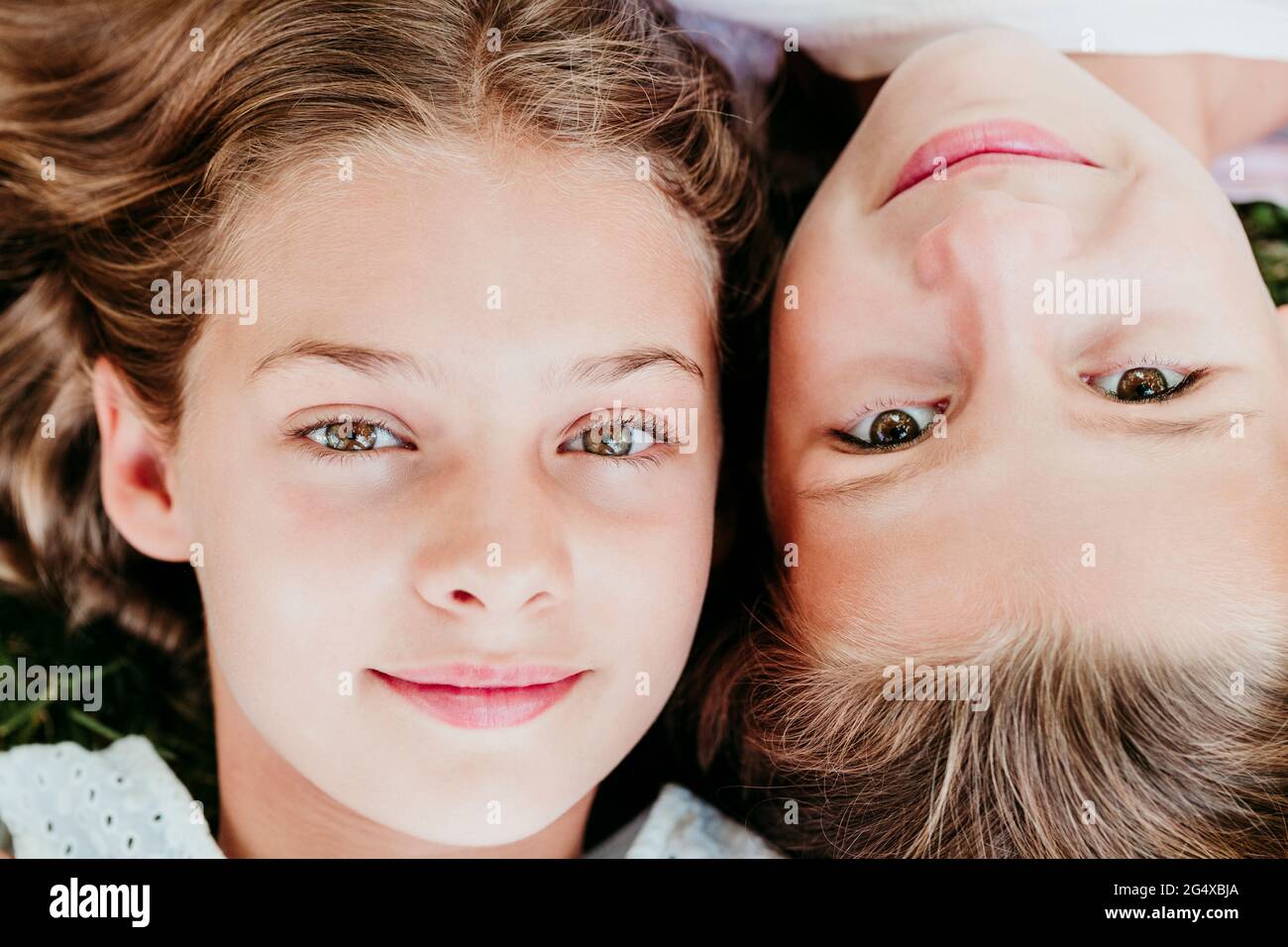 Smiling girls lying side by side Stock Photo