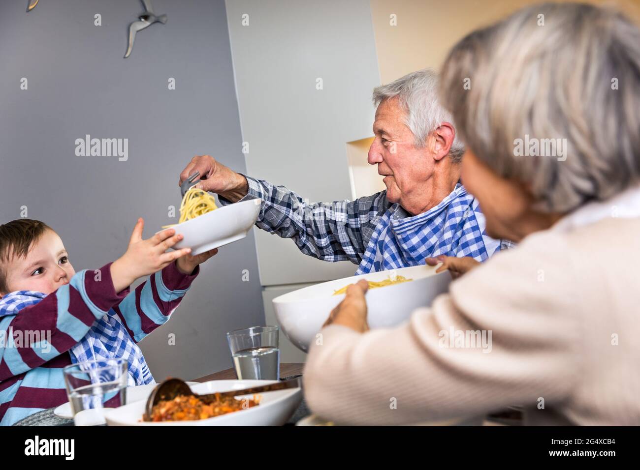 Multi-generation family having food together at home Stock Photo