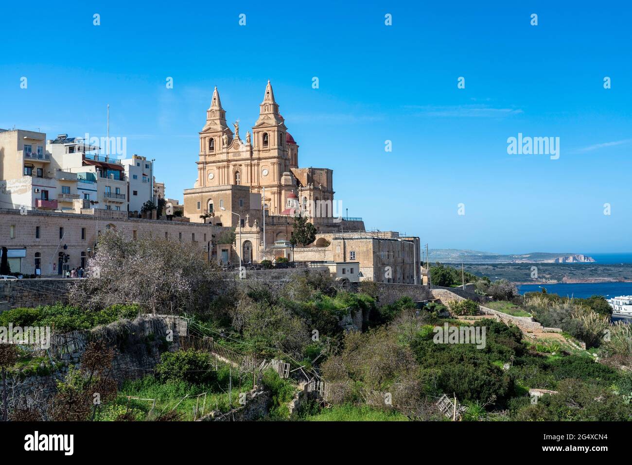Malta, Northern Region, Mellieha, Edge of town with Parish Church of Nativity of Virgin Mary in background Stock Photo